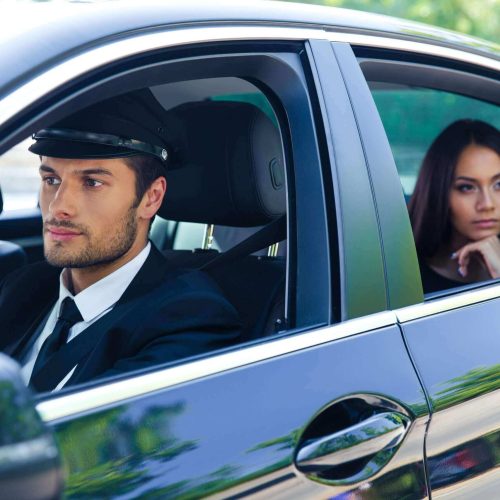 driver and women sitting in car